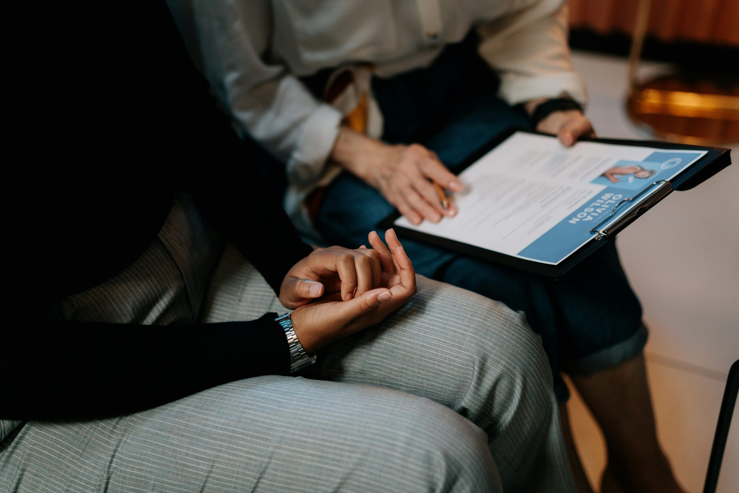 Two professionals reviewing a resume in an office setting, focused on teamwork.